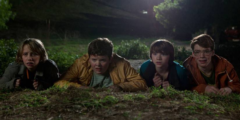 The kids lie in the grass in Super 8