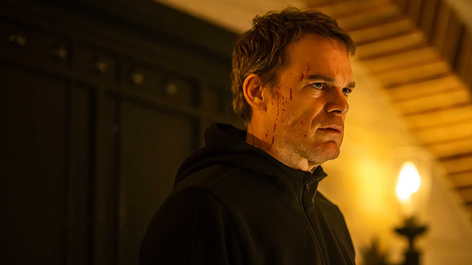Dexter standing in the museum, blood on his face, in Dexter: Resurrection