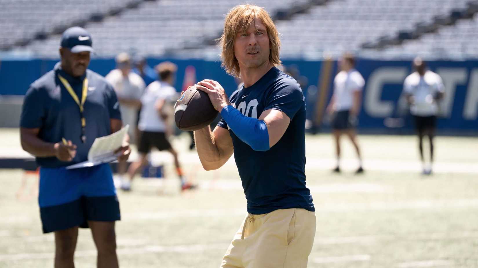 Glen Powell throws a football as the titular character in Chad Powers