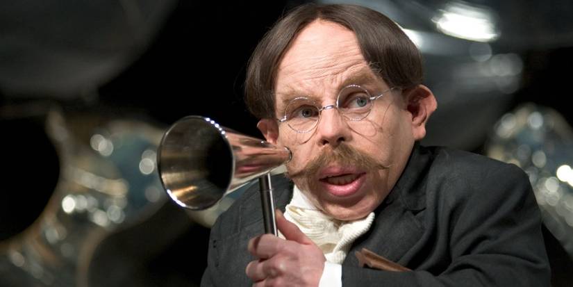 Professor Flitwick holds a telescope in Harry Potter