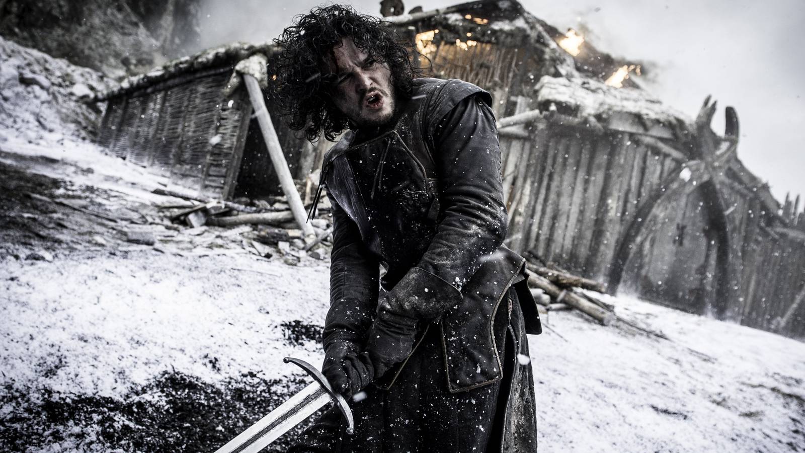 Kit Harington in Game of Thrones as Jon Snow wielding a sword in the snow at Hardhome