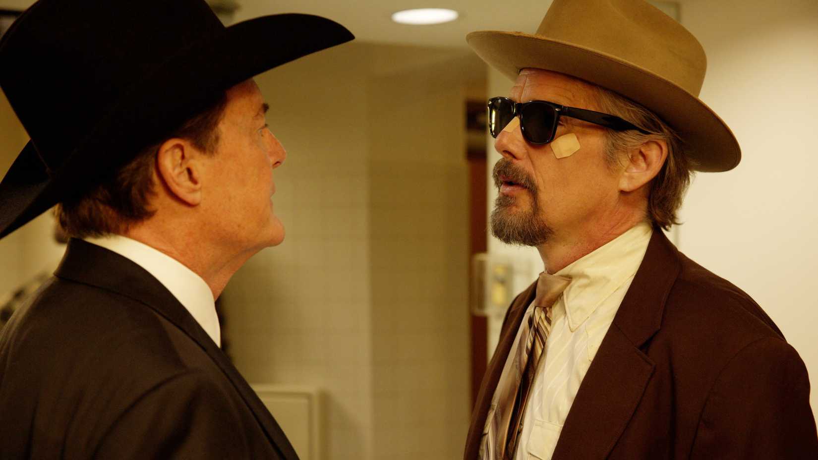 Kyle MacLachlan and Ethan Hawke in The Lowdown staring at each other