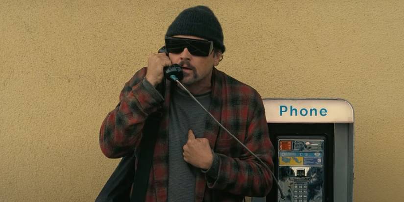 Leonardo DiCaprio talking on a public phone in one battle after another