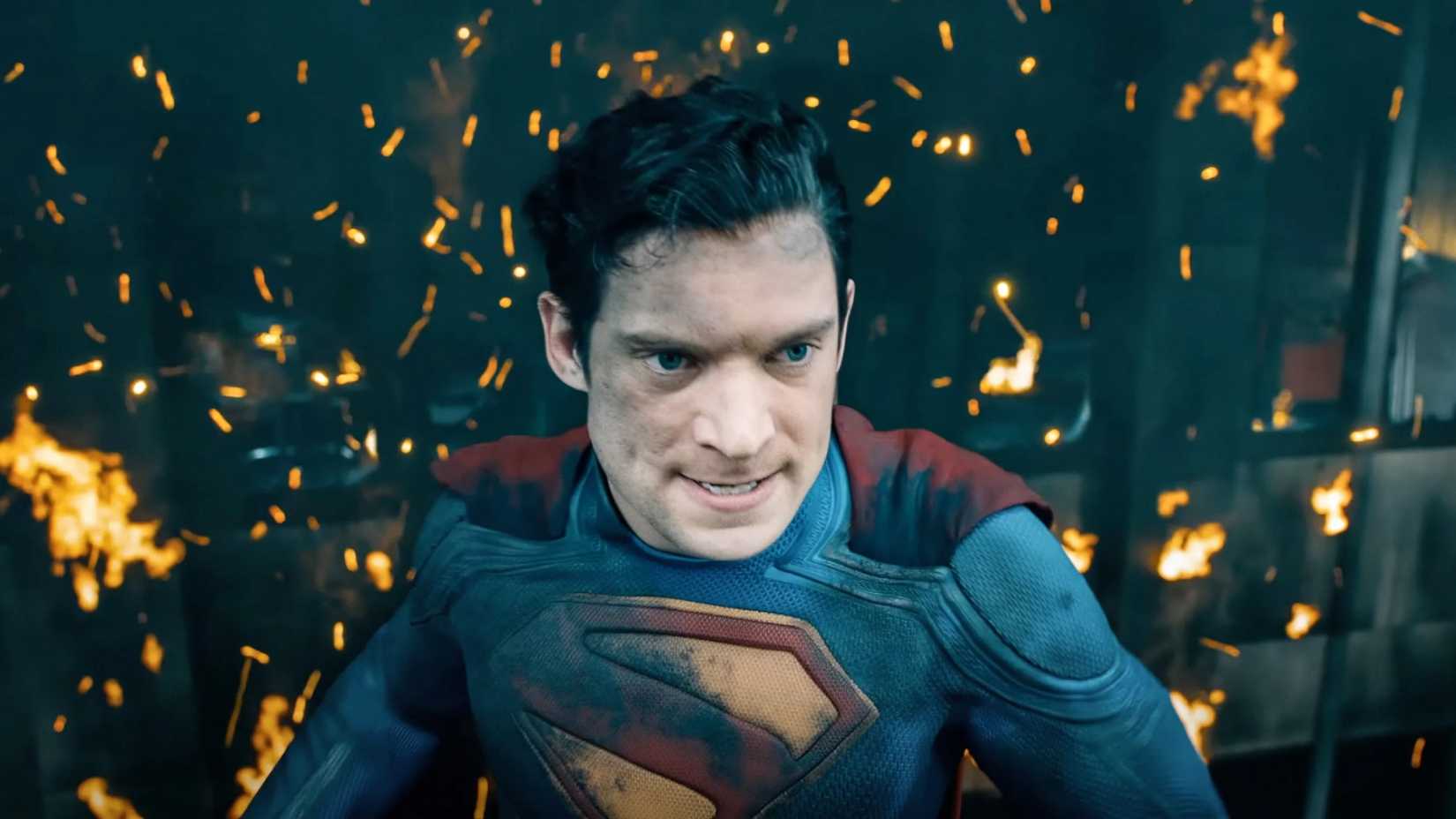 David Corenswet stands in front of flames in Superman