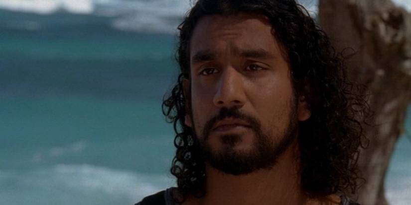 Naveen Andrews as Sayid on Lost sitting next to a tree