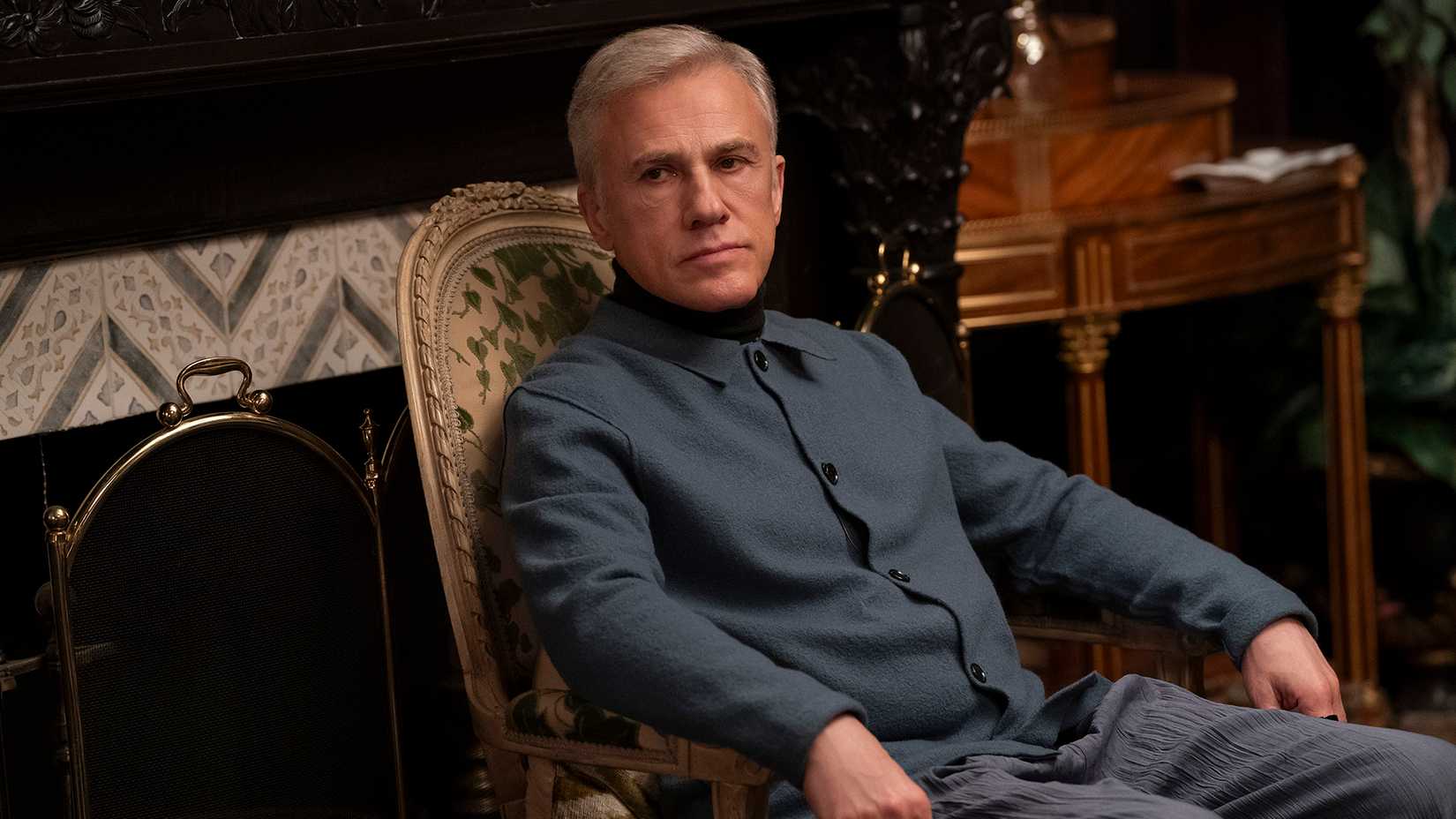 Bash sitting stone-faced in a chair in Only Murders in the Building.