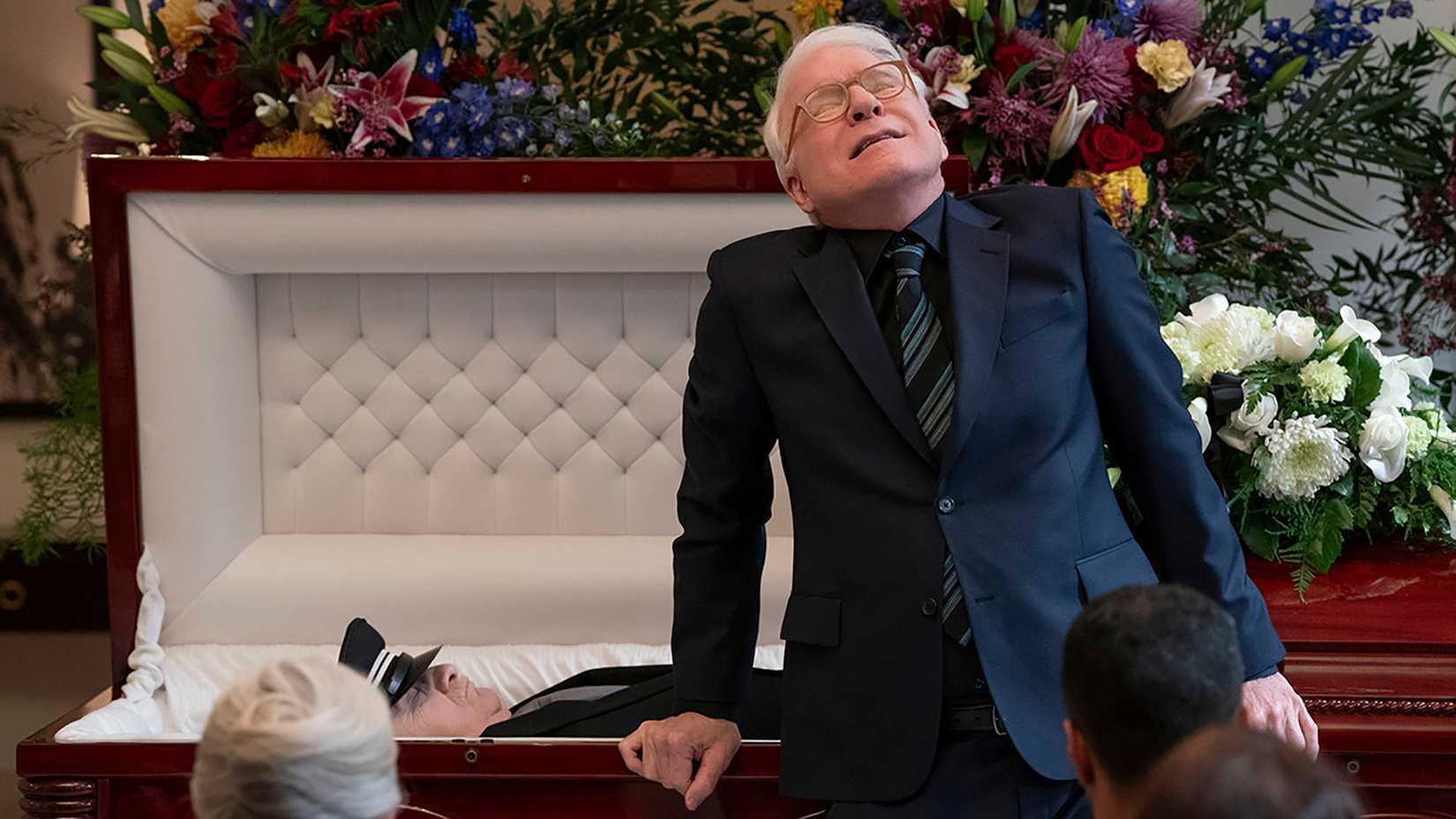 Charles leaning over Lester's coffin, fake crying in Only Murders in the Building.