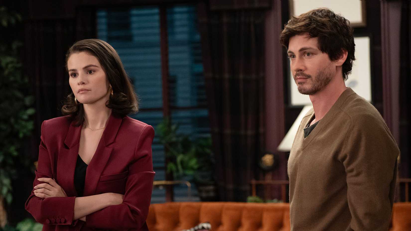 Mabel with her arms folded standing beside Jay in Only Murders in the Building.