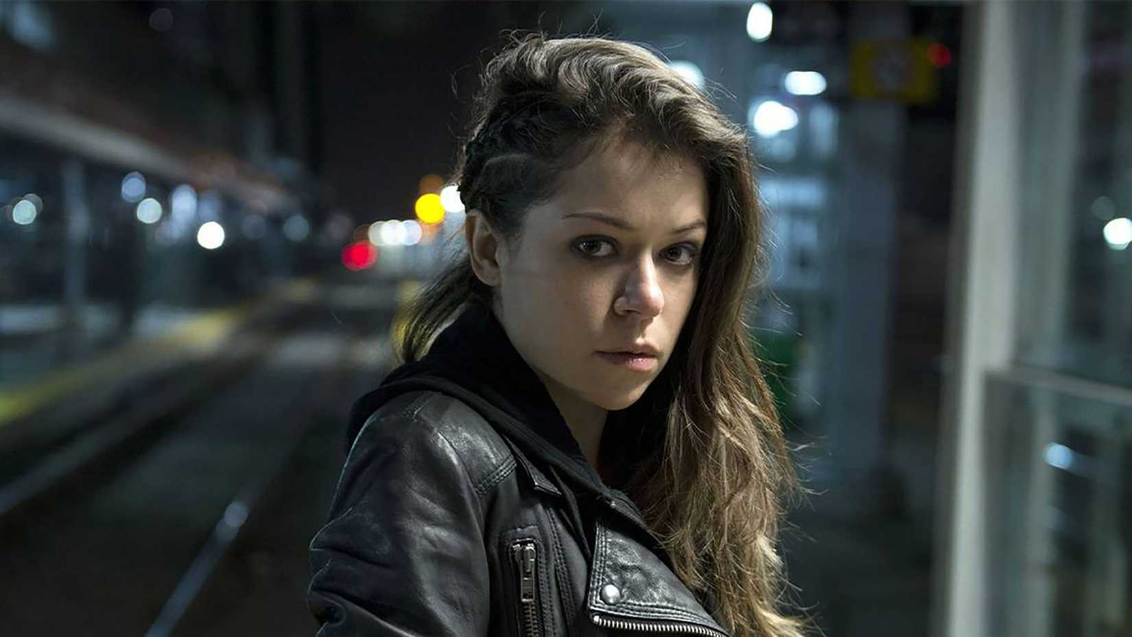 Sarah standing in the street glaring at the camera in Orphan Black.