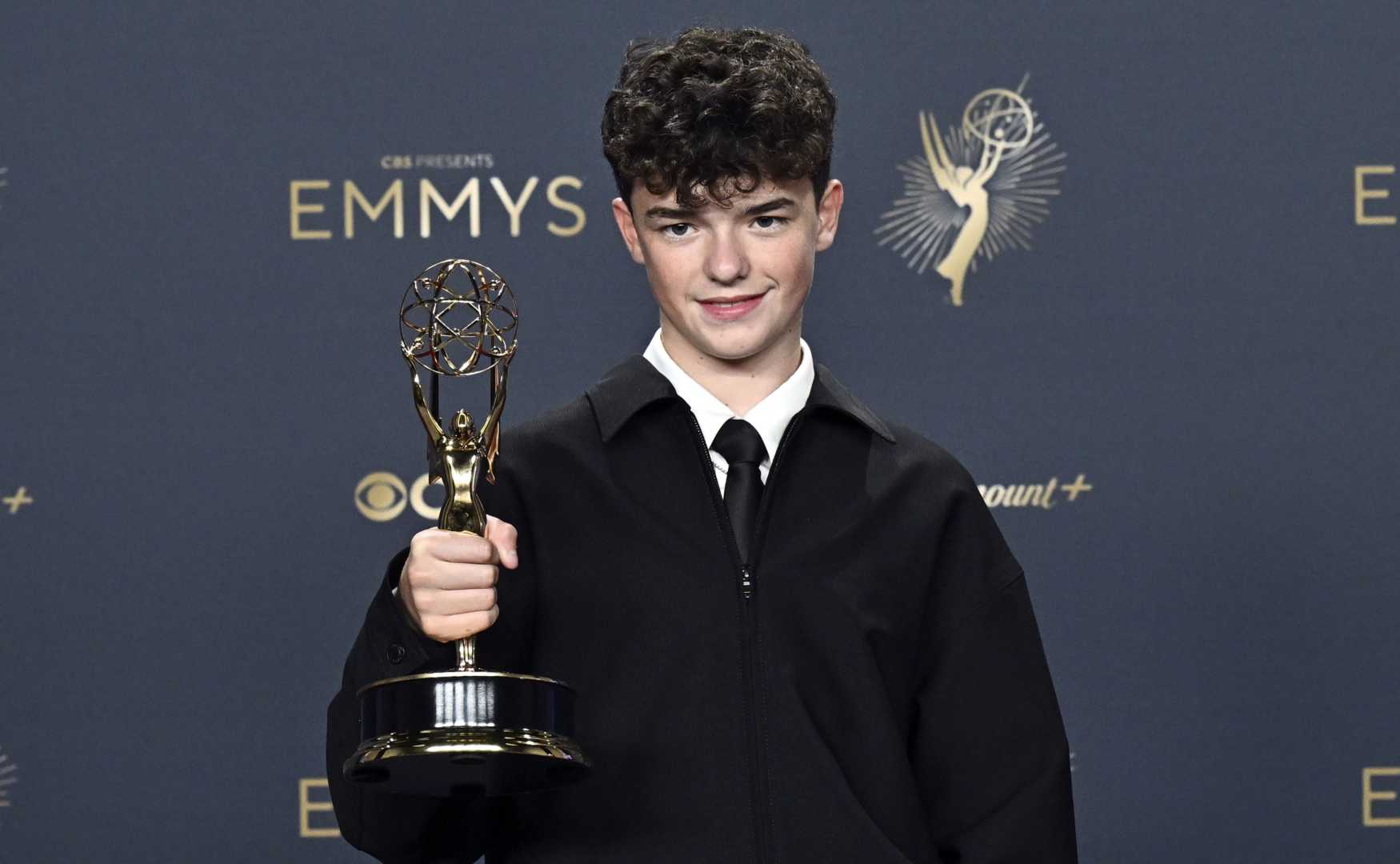 Owen Cooper posing with his award at the Emmys