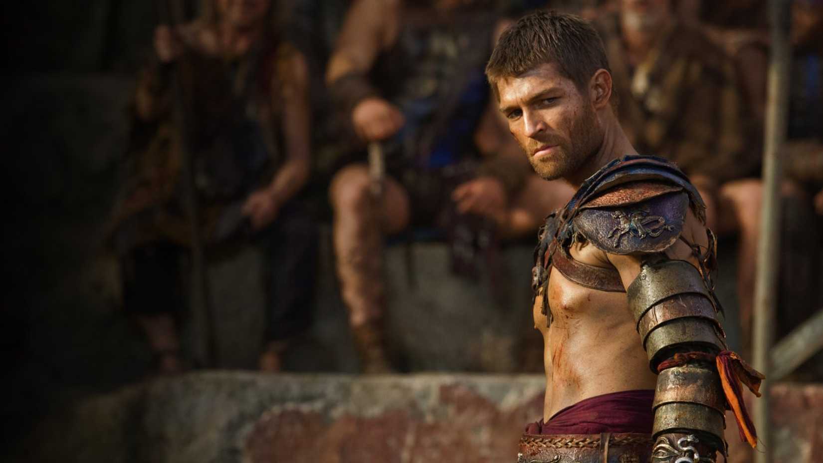 Spartacus stands in the arena in Spartacus, wearing armor and preparing for a fight