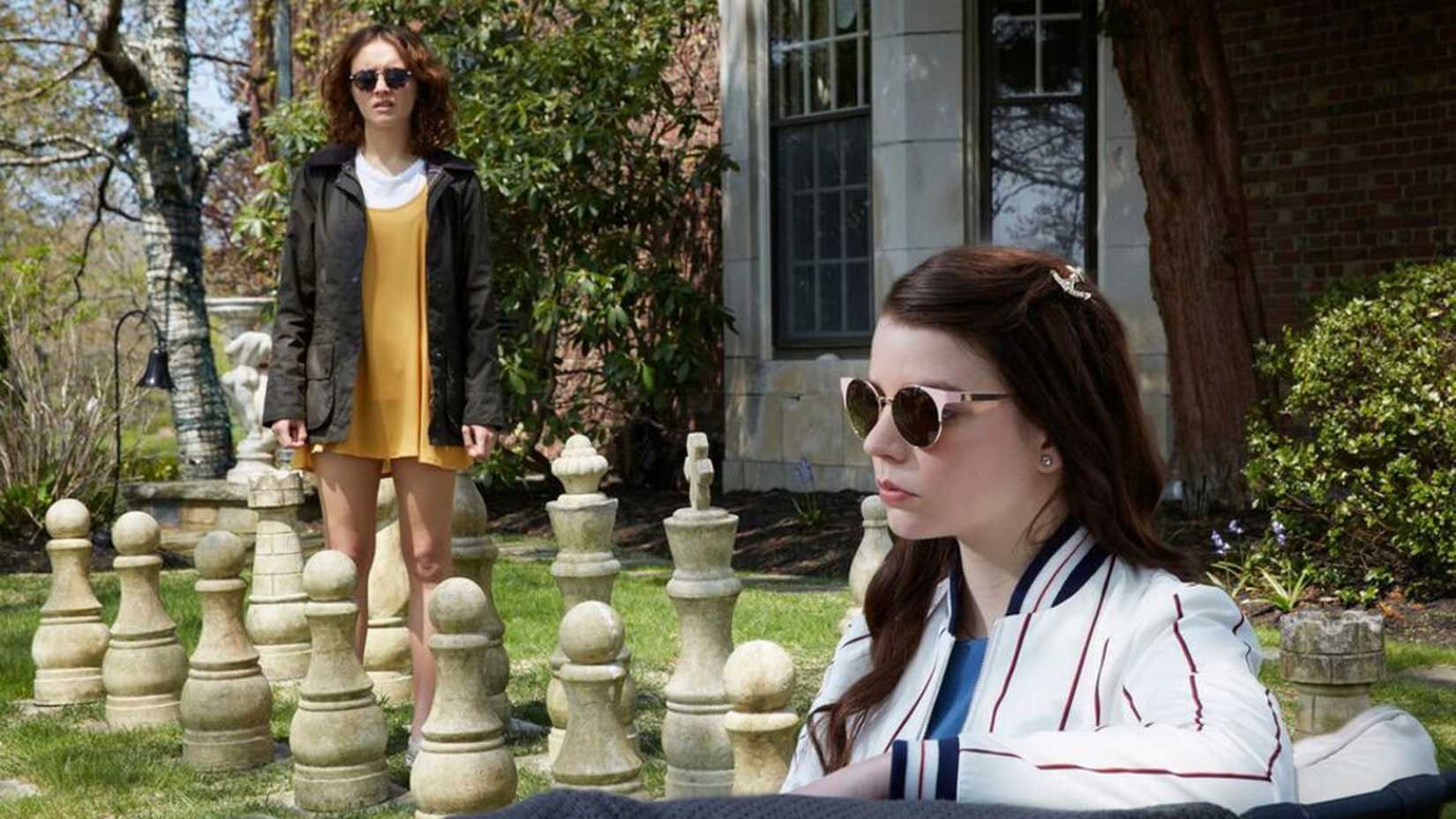 Amanda and Lily pose by outdoor chess pieces in Thoroughbreds