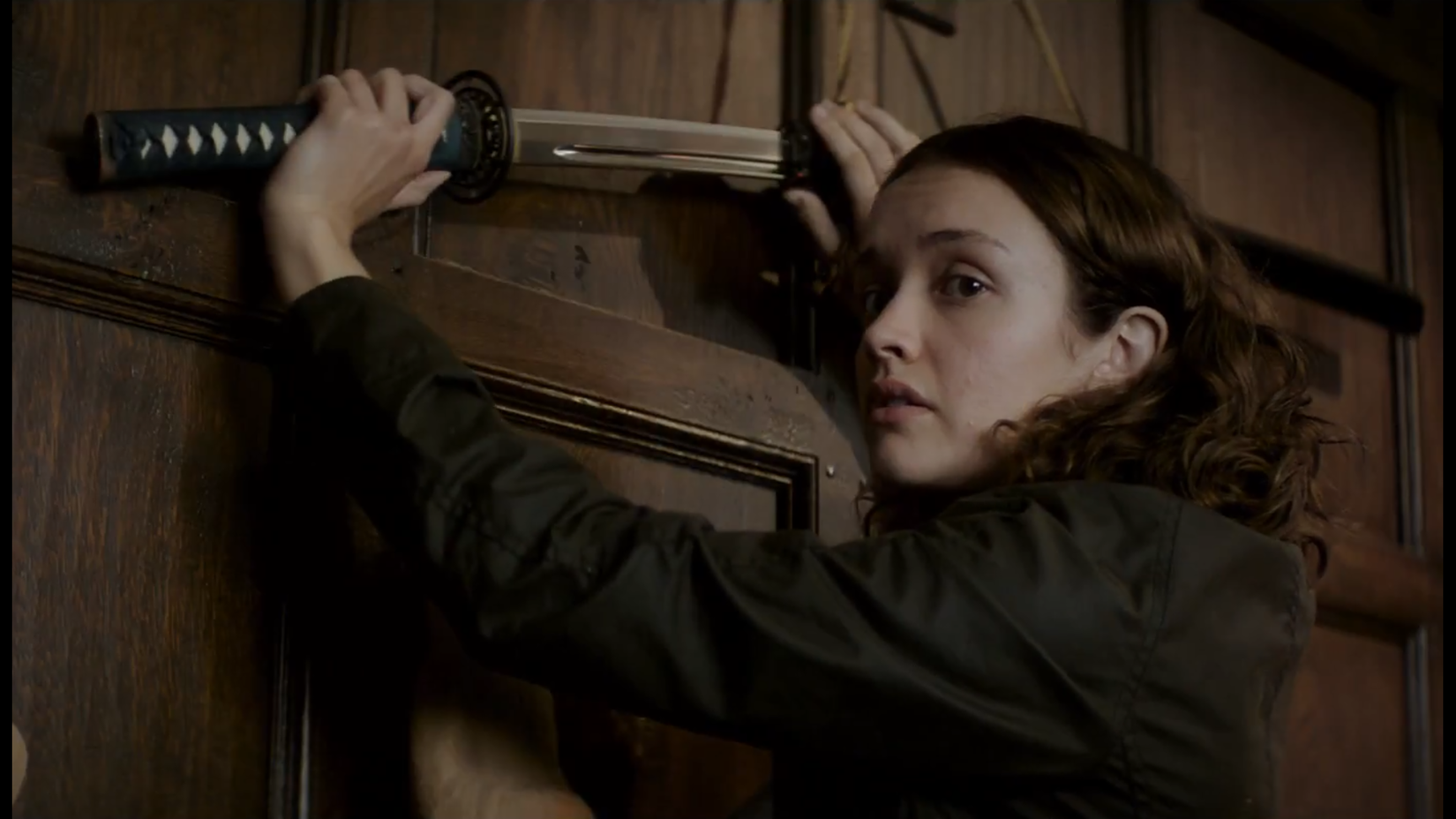 Amanda pulls a sword from the wall in Thoroughbreds