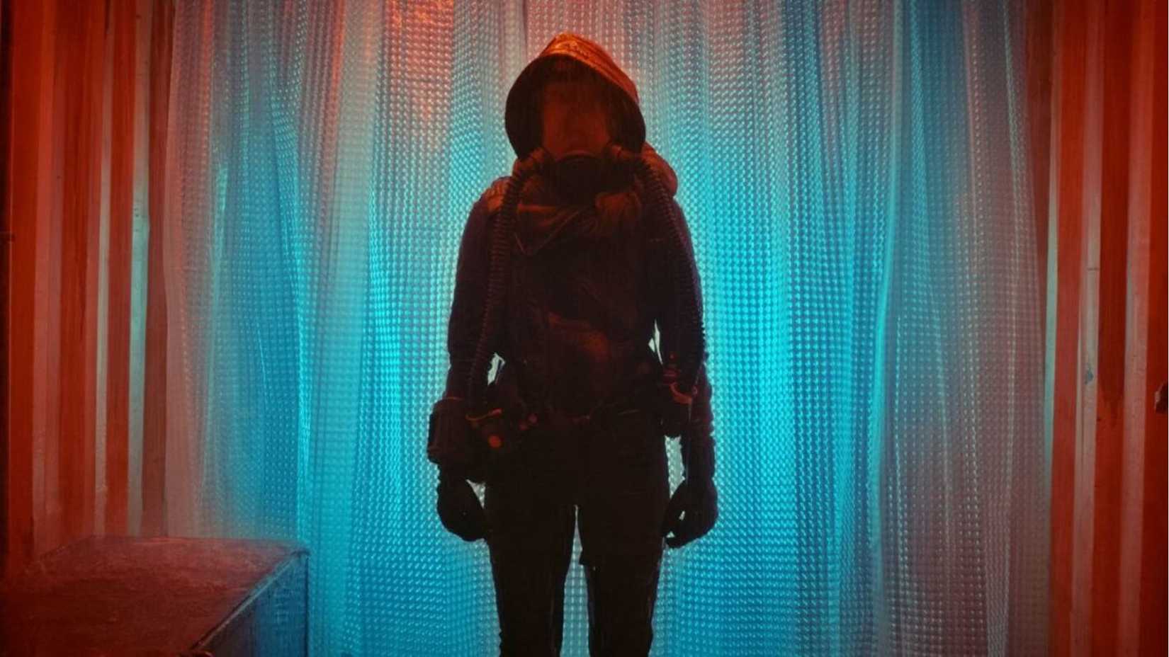 A woman standing against a colorful backdrop in The Last Spark of Hope (2023)
