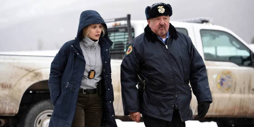 Jane and Ben stand by a truck in Wind River