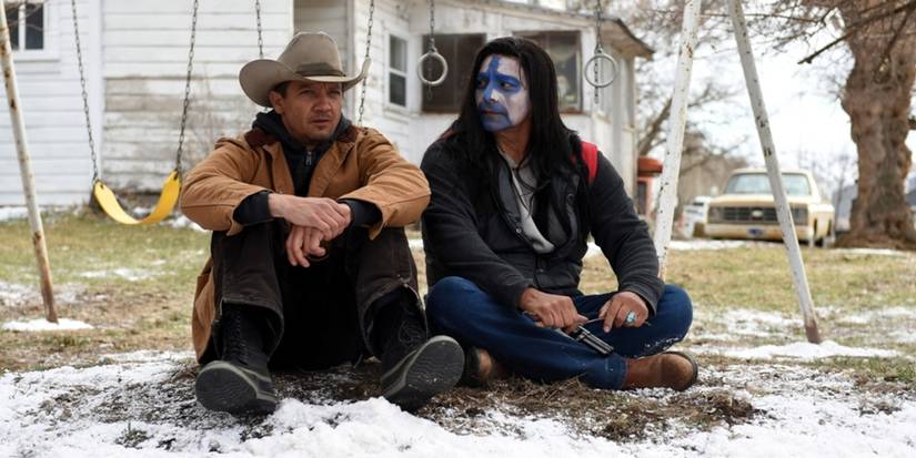 Cory and Martin sit in the snow in Wind River