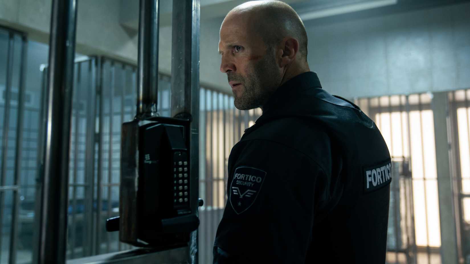 Jason Statham in Wrath of Man wearing a security vest and uniform