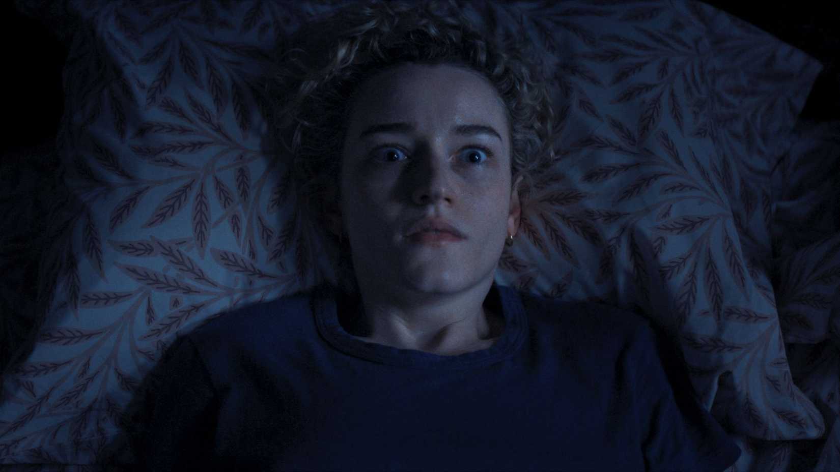 Julia Garner awake in bed in 'Weapons'