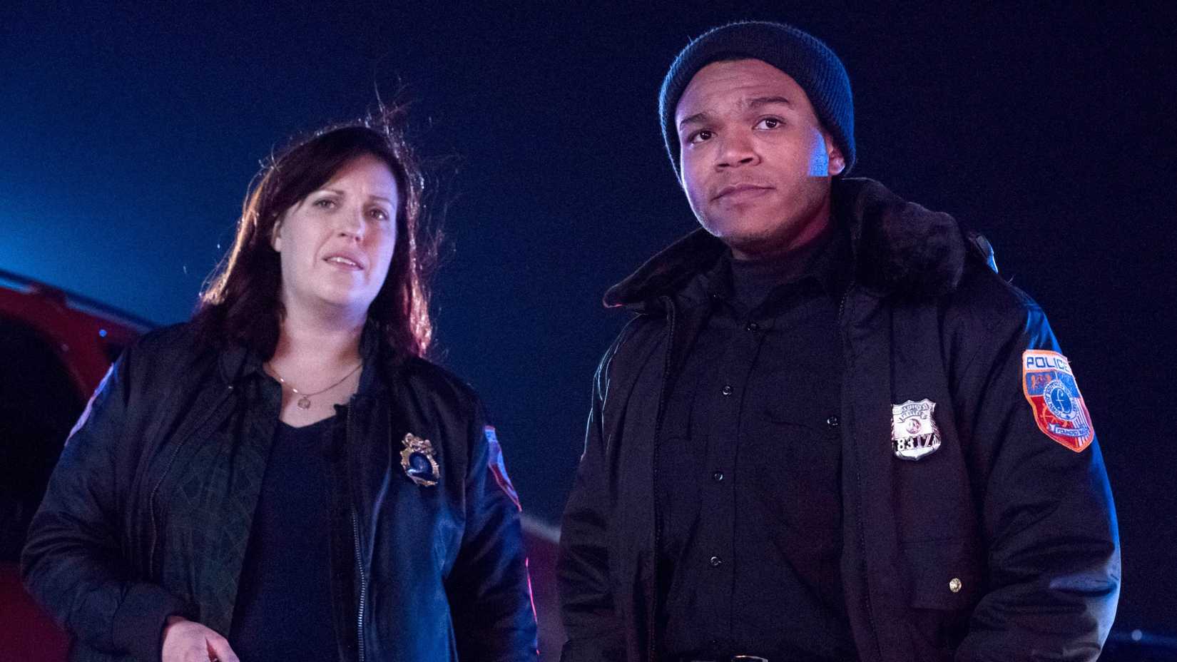 Allison Tolman and Robert Bailey Jr. in Emergence wearing police uniforms looking off-screen