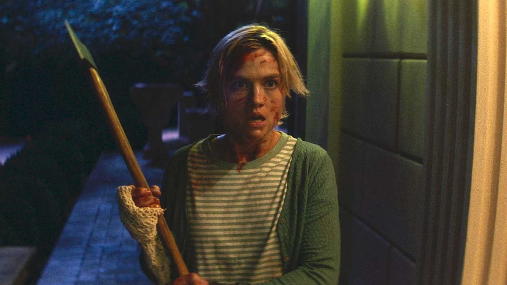 Sage holds an ax in Bone Lake