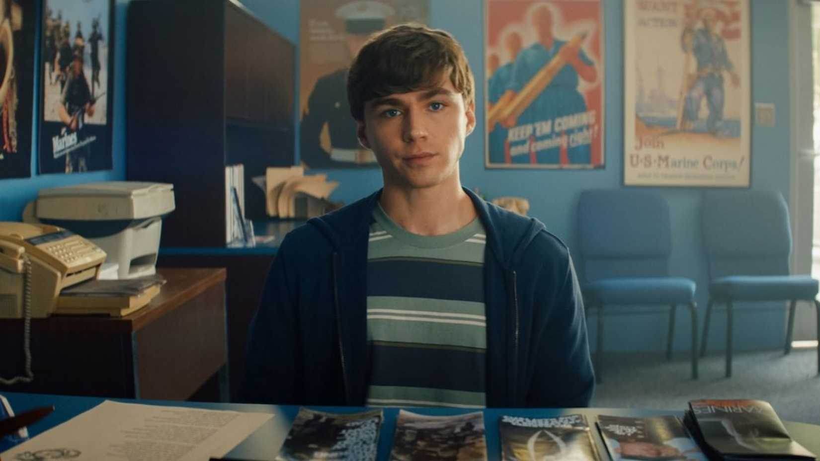 Cam sits at his desk in Boots