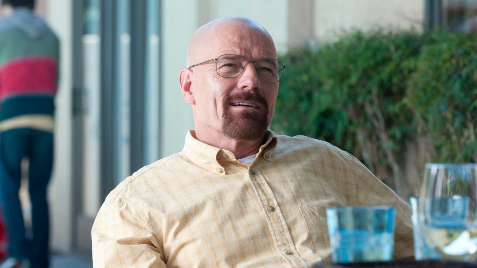 Bryan Cranston in Breaking Bad sitting at a table in his backyard