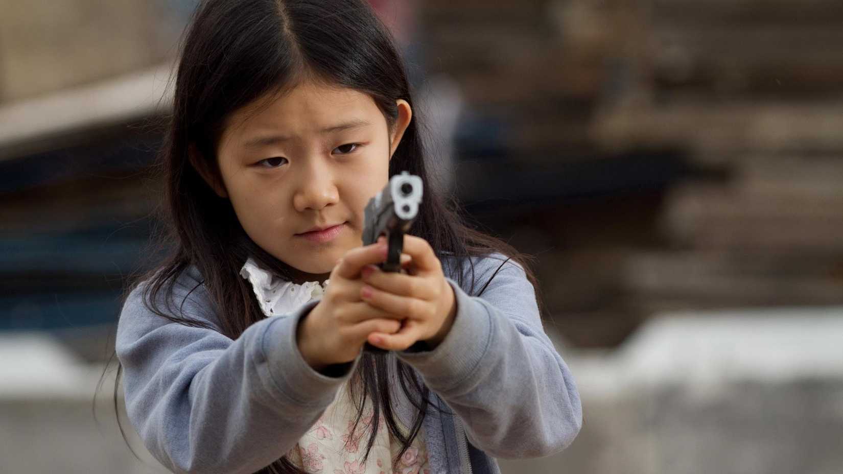 Catherine Chan as Mei pointing a gun in 2012's Safe
