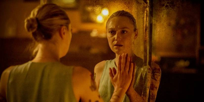 Dakota Fanning looks in the mirror in Vicious