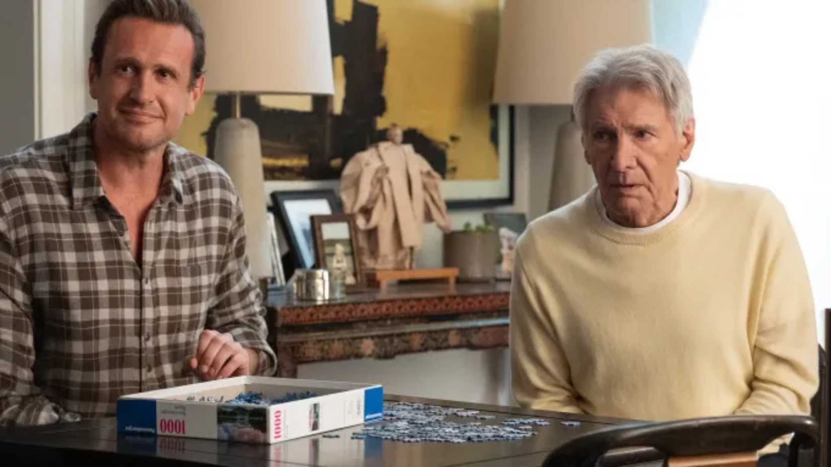 Jason Segel and Harrison Ford in Shrinking doing a puzzle together.