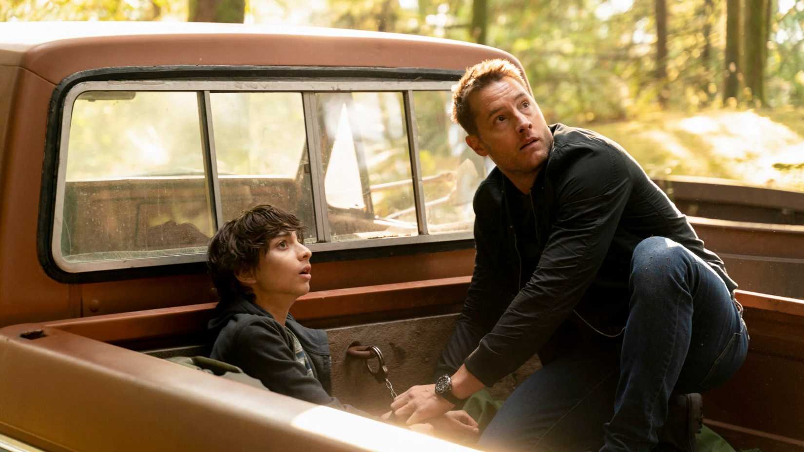 Justin Hartley as Colter Shaw in Tracker helping a young boy chained to a pickup truck