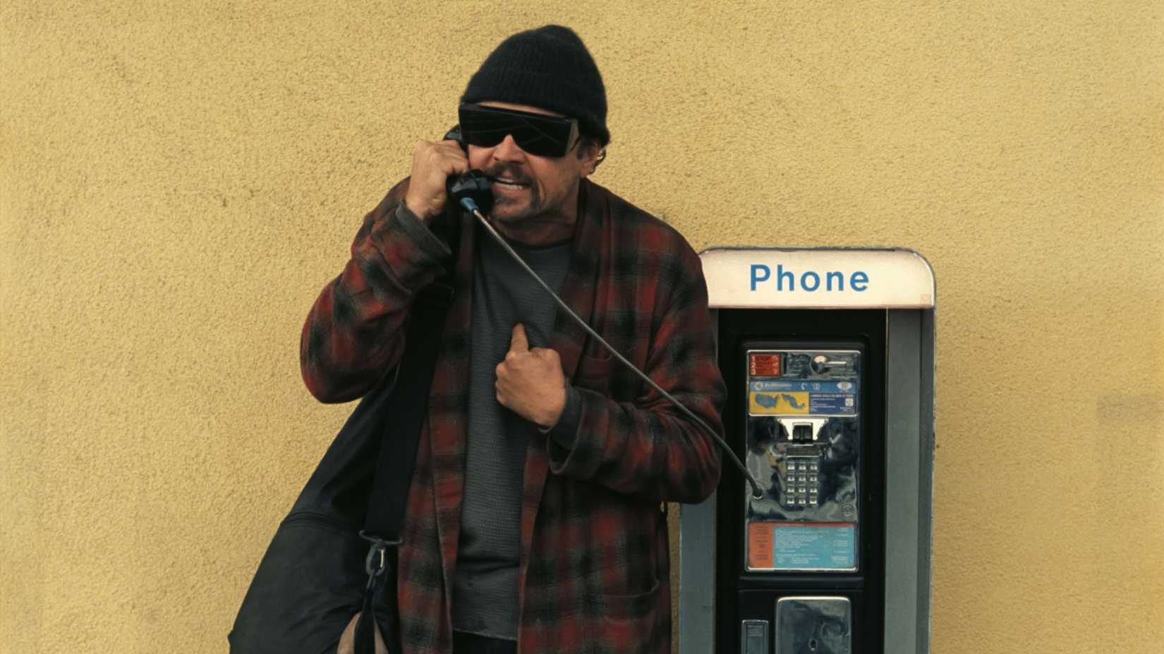 Leonardo DiCaprio in One Battle After Another using a pay phone