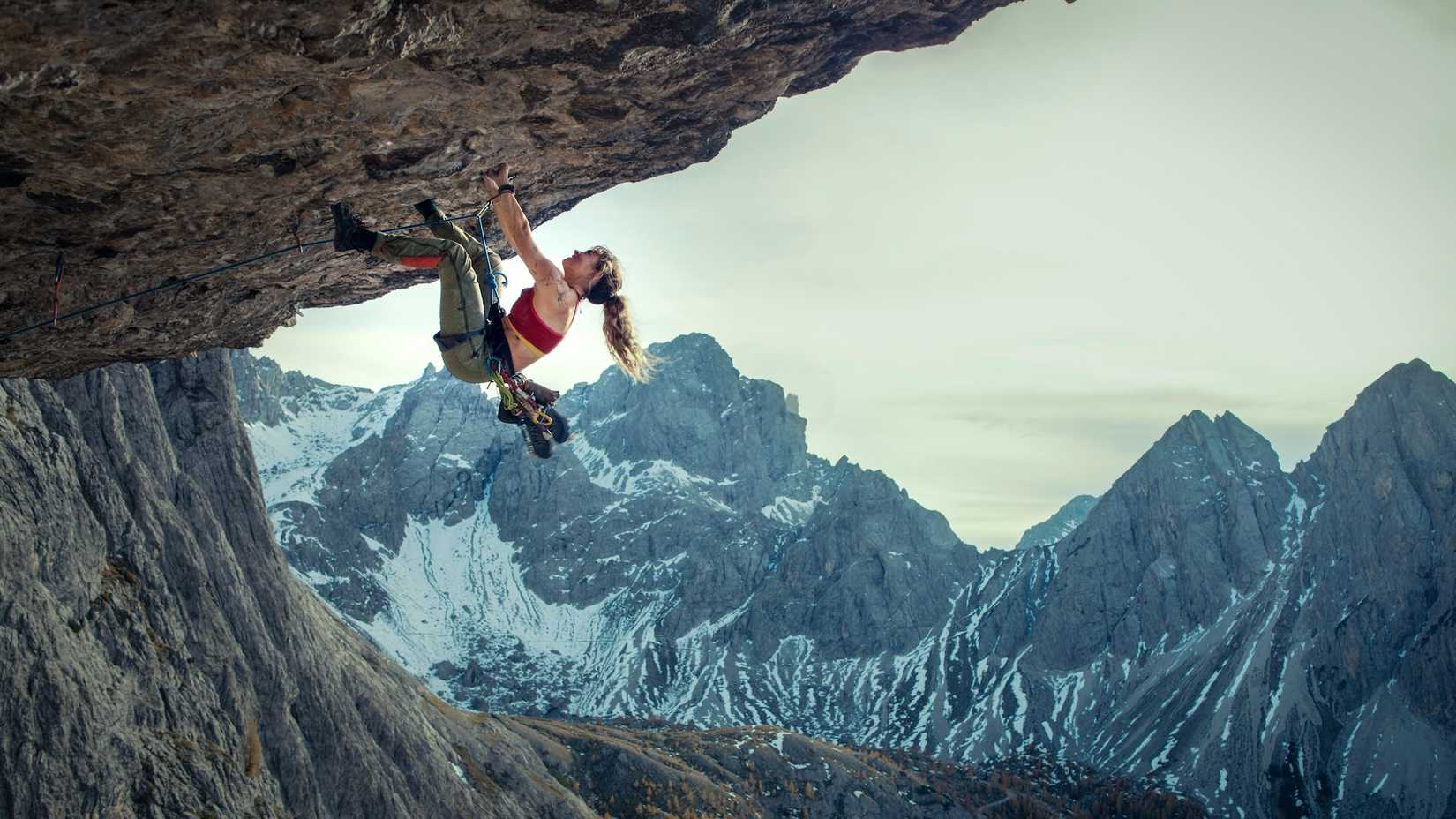 Lily James' Naomi Cooper scaling a mountain in Jaume Collet-Serra's Cliffhanger reboot