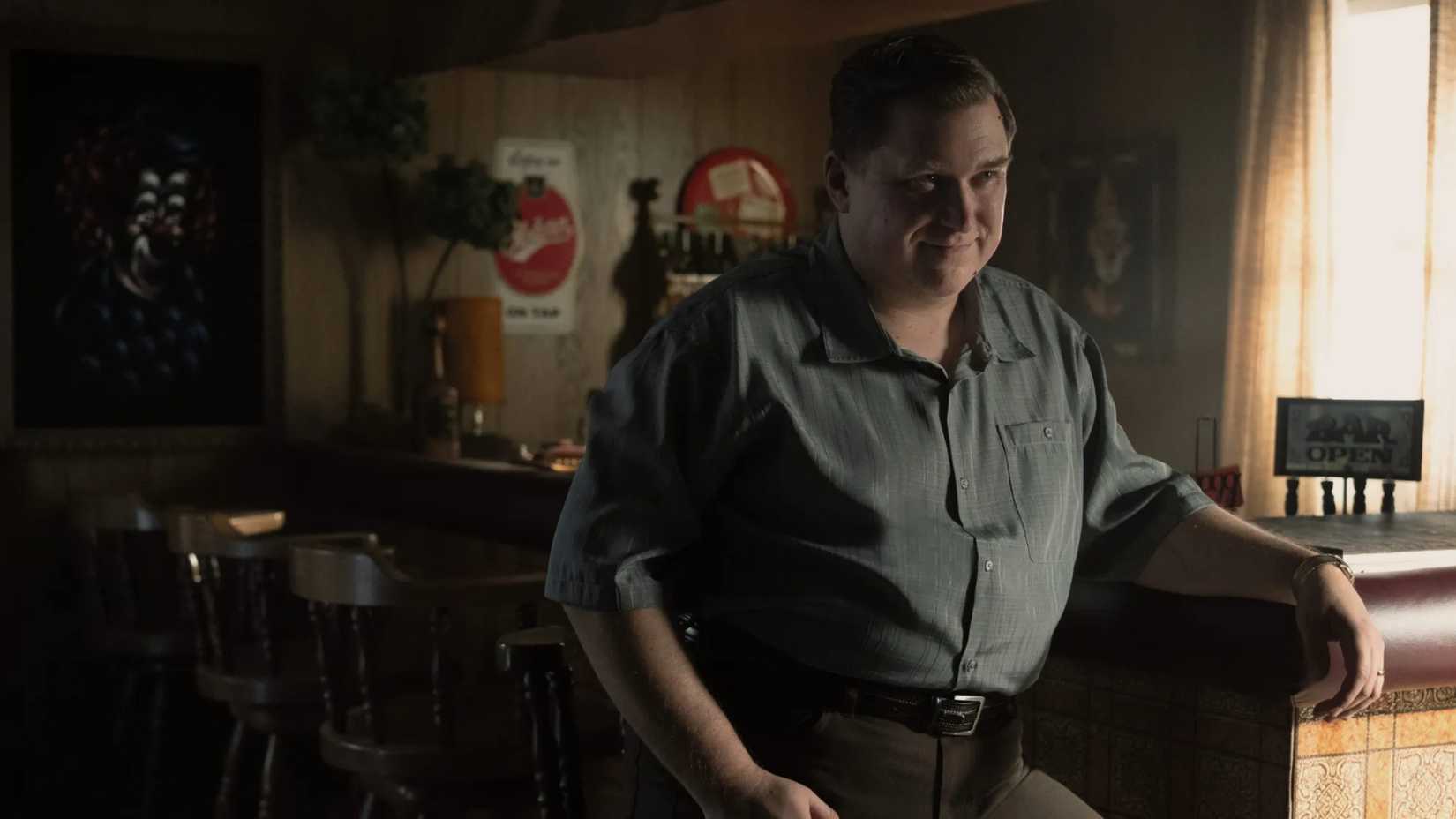 Michael Chernus as John Wayne Gacy in Devil in Disguise standing in a bar