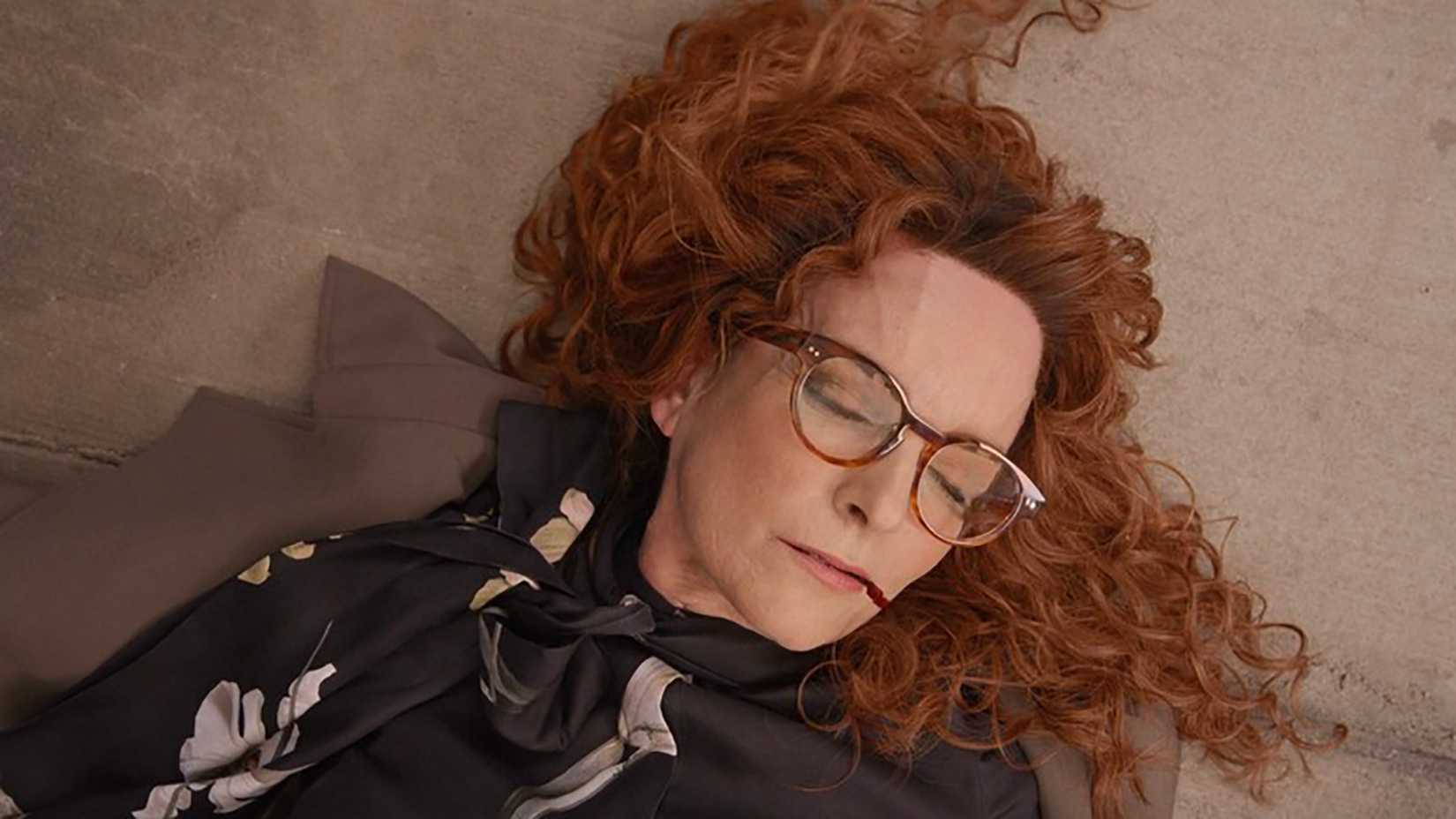 Cinda with curly red hair dead on the ground in Only Murders in the Building.