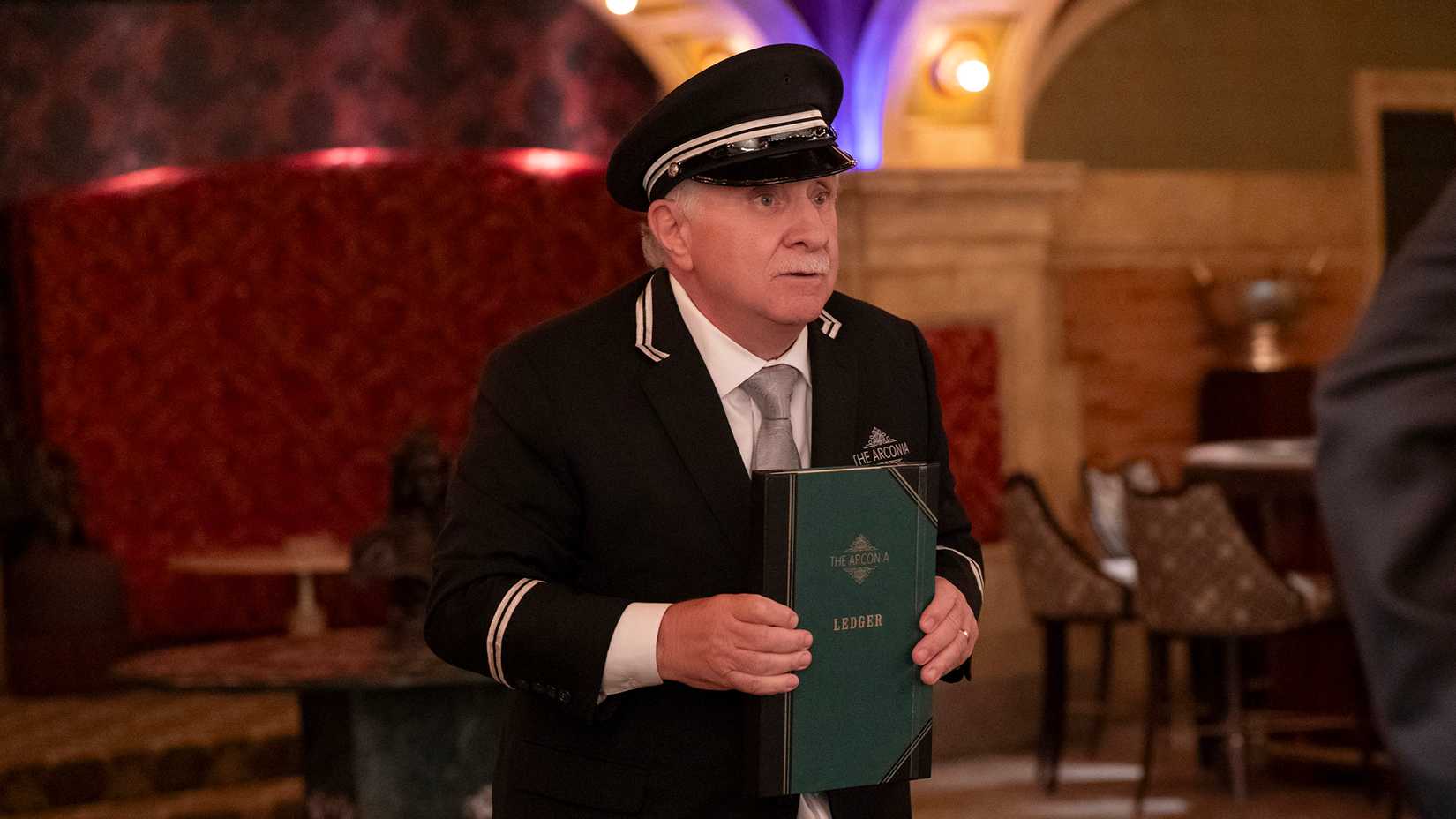 Lester in the casino holding his ledger in Only Murders in the Building.