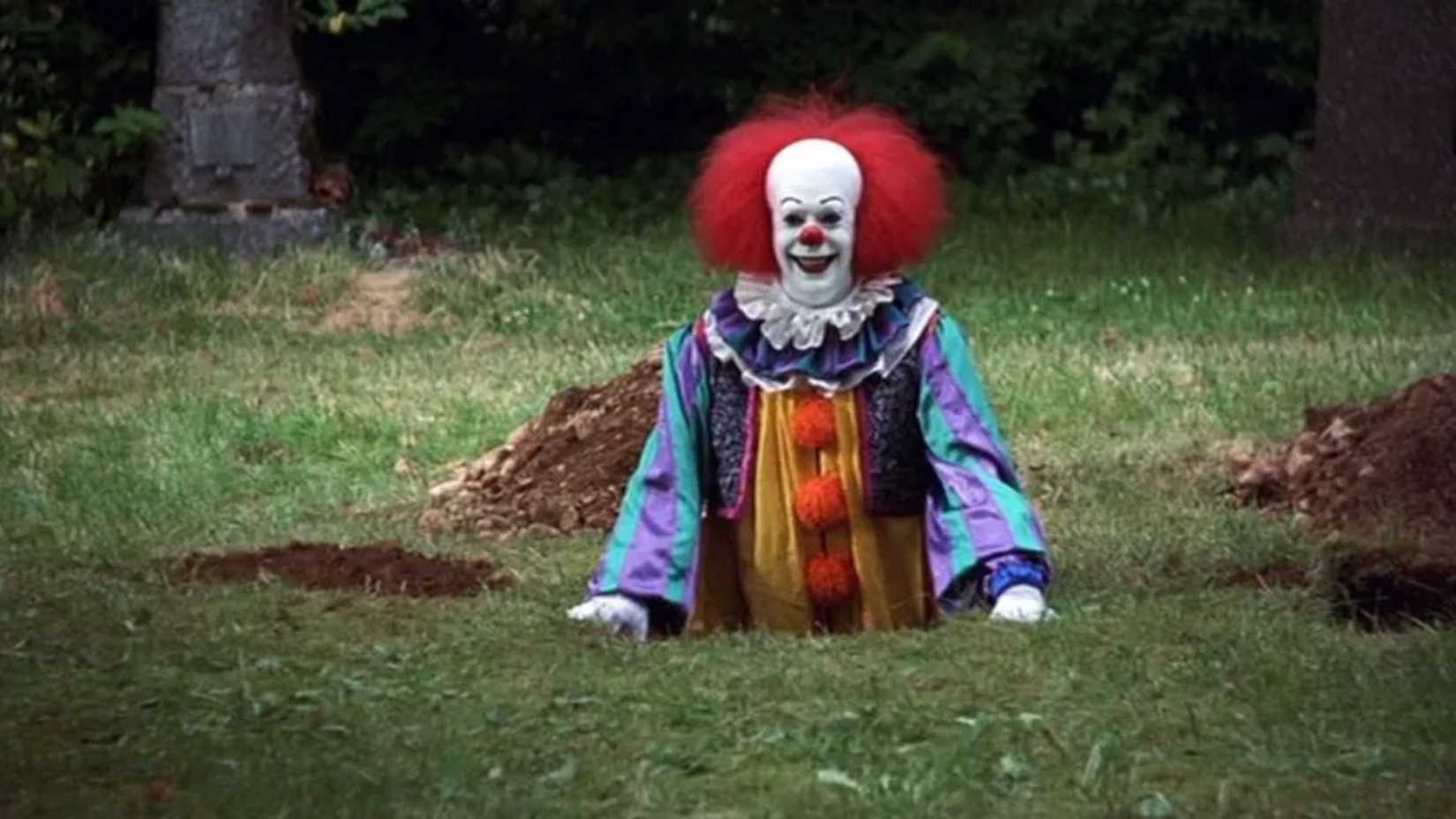 pennywise smiles from a hole in the ground in the 1990 miniseries It