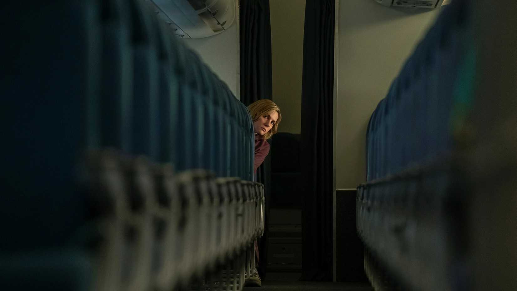 Carol at the front of any empty plane looking back in Pluribus.