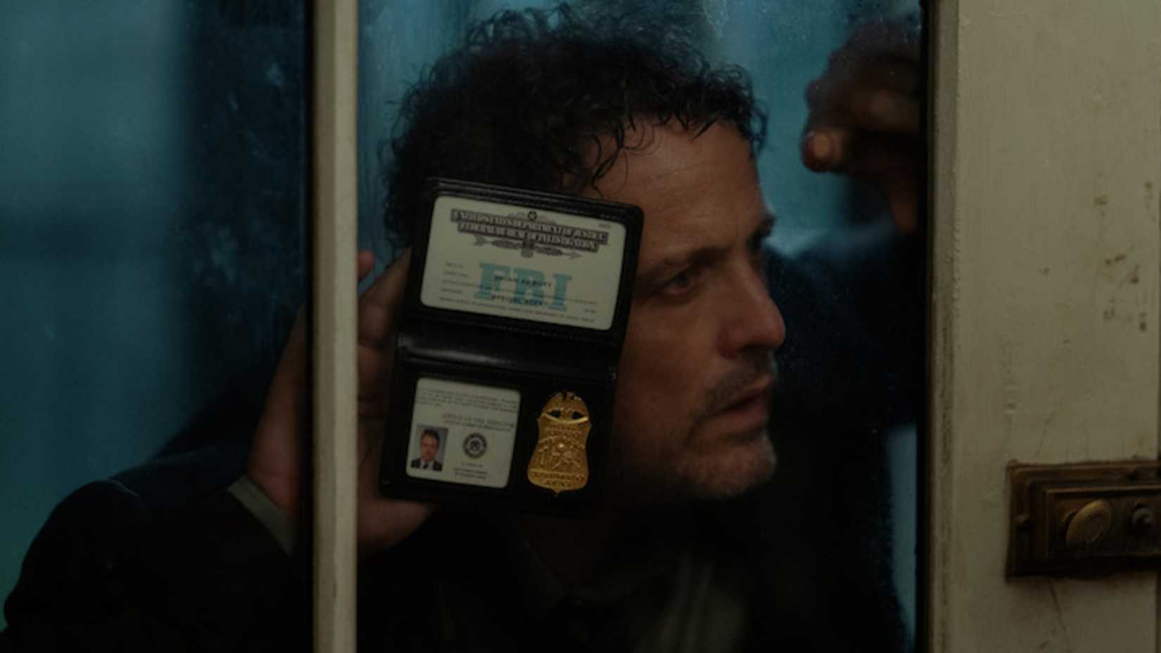 Agent Abbott flashes his FBI badge in The Beast in Me