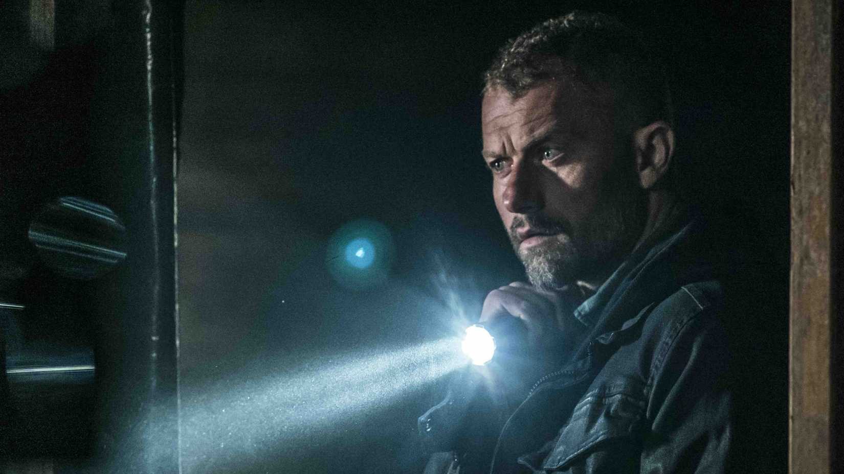 James Lasombra (James Badge Dale) holds a flashlight in The Empty Man (2020)
