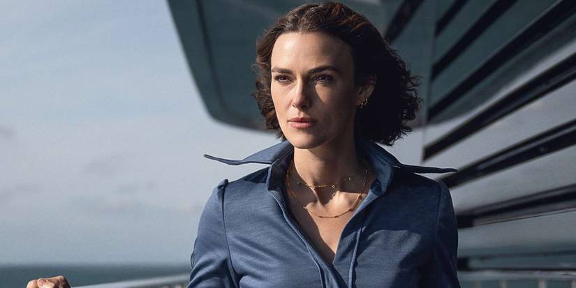 Lo stands on a deck in The Woman in Cabin 10