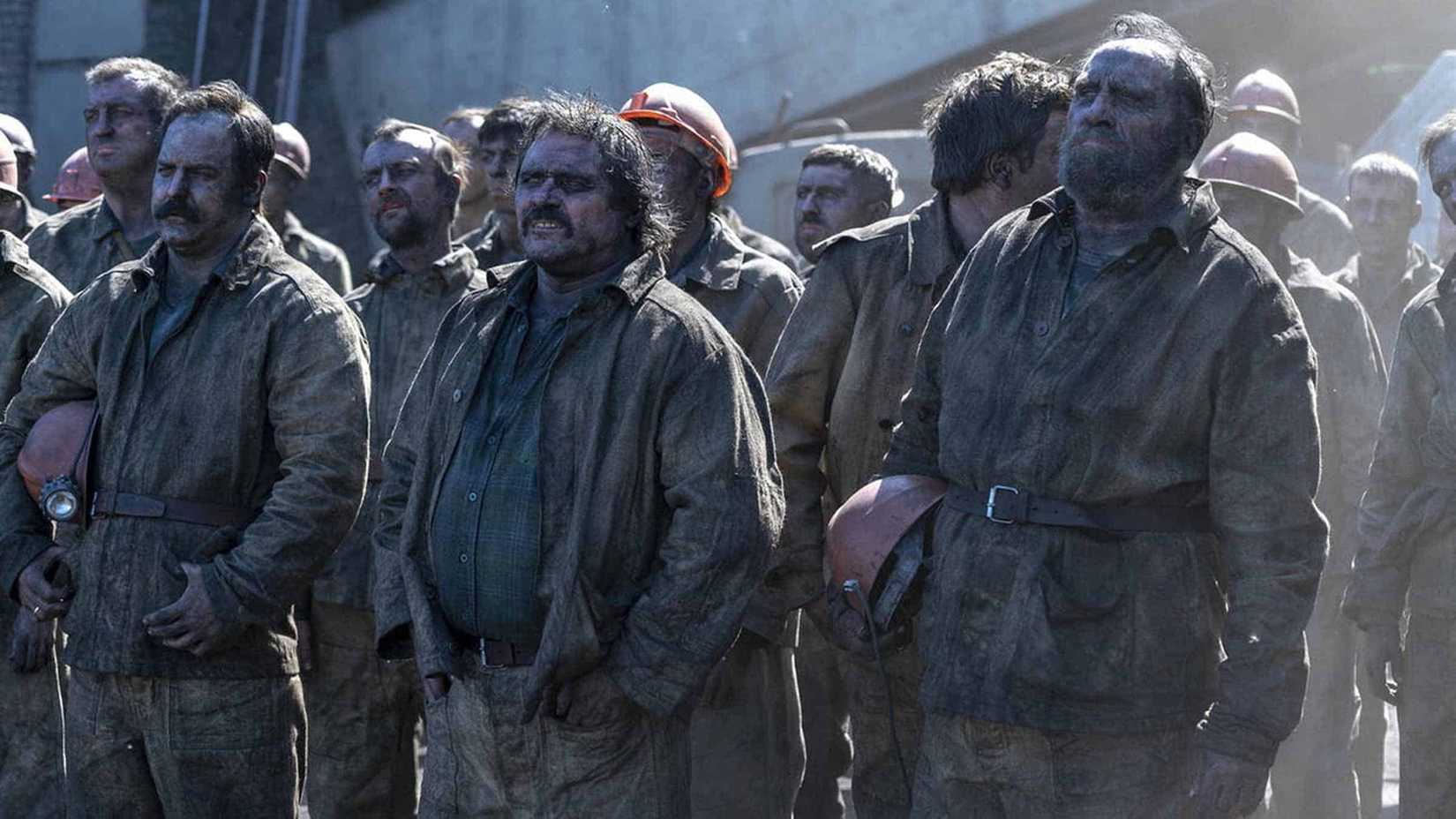 Miners all dirty standing together in Chernobyl.