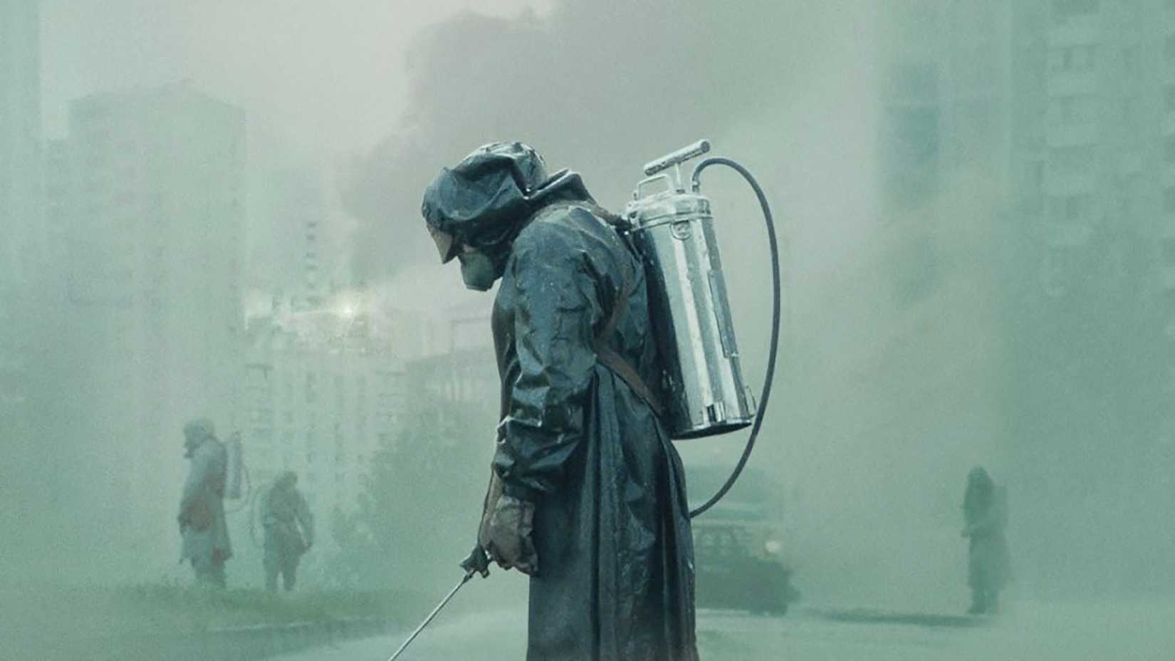 A man in a suit spraying with a radioactive cloud around him in Chernobyl.