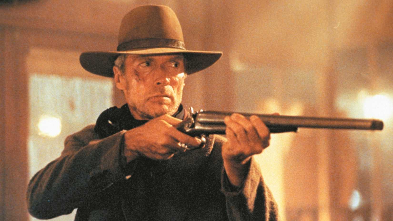 Clint Eastwood in Unforgiven aiming a shotgun at someone off-screen