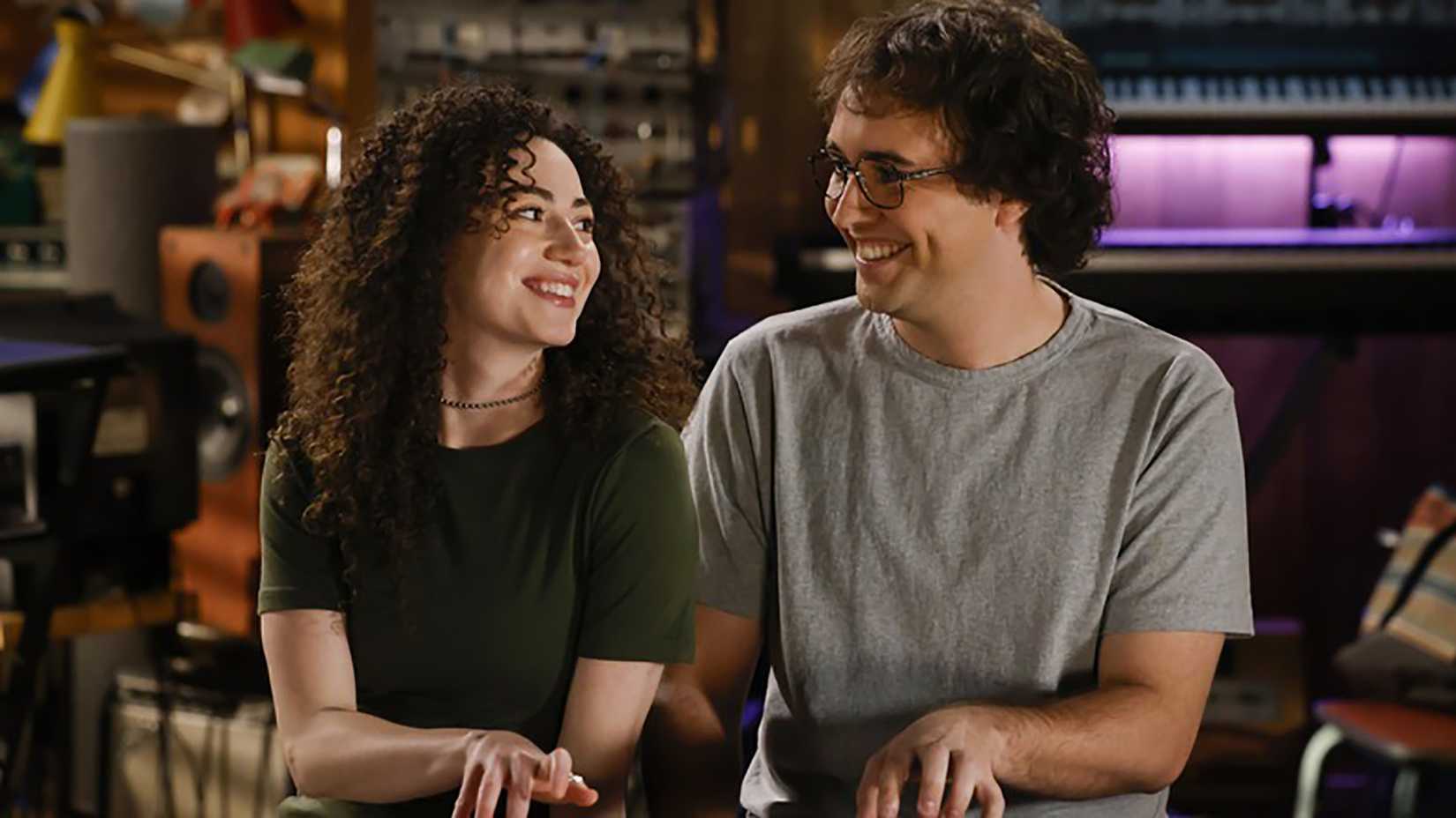 Chloe and Connor smiling at one another while me plays the keyboard in Georgie & Mandy's First Marriage.