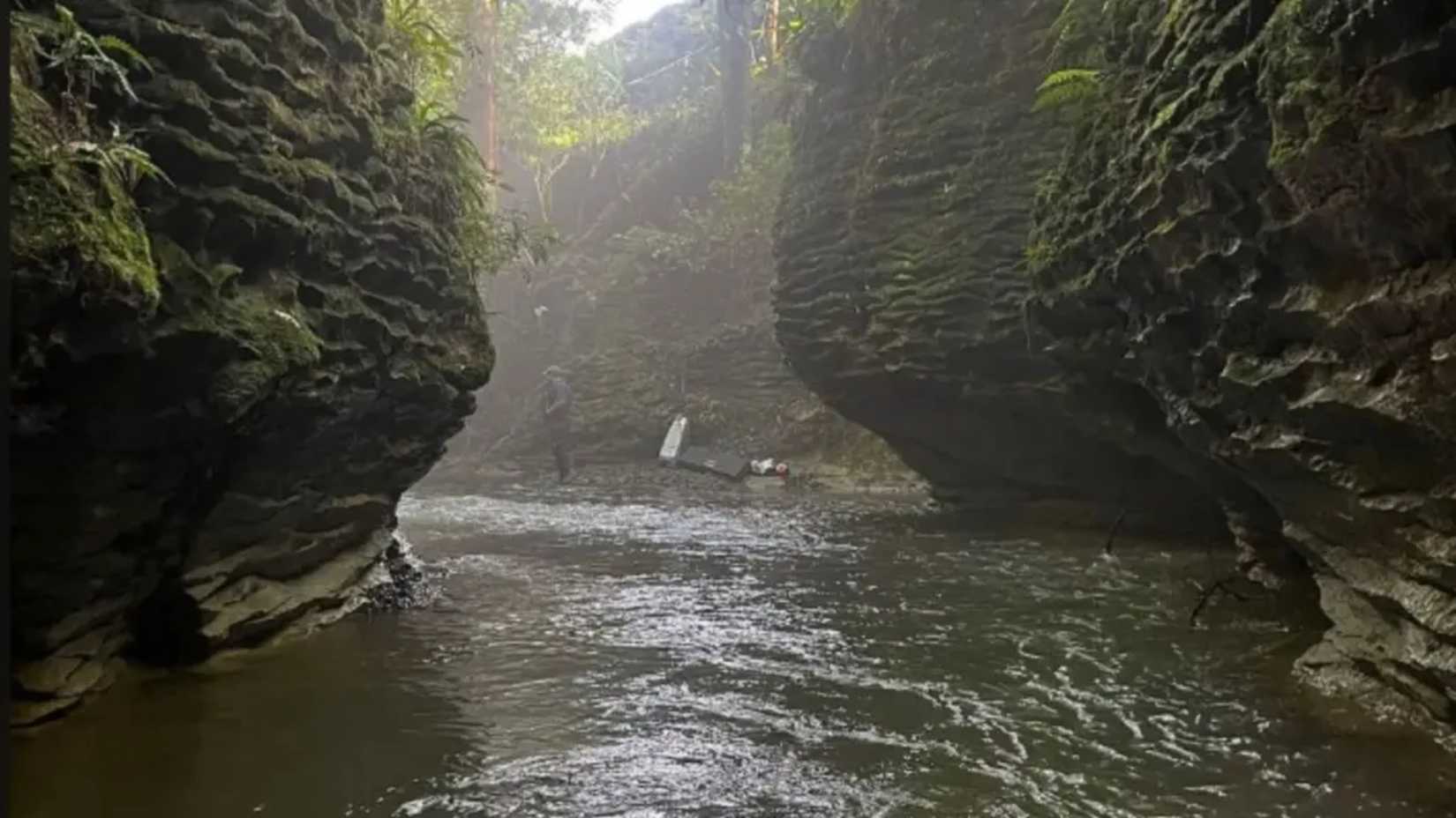 A man and woman are seen on a river bank in Predator: Badlands