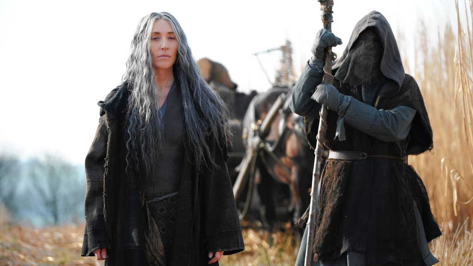 Annora walks through a field in The Bastard Executioner