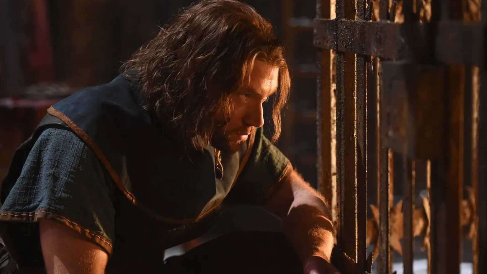 Maddox sits by a cage in The Bastard Executioner