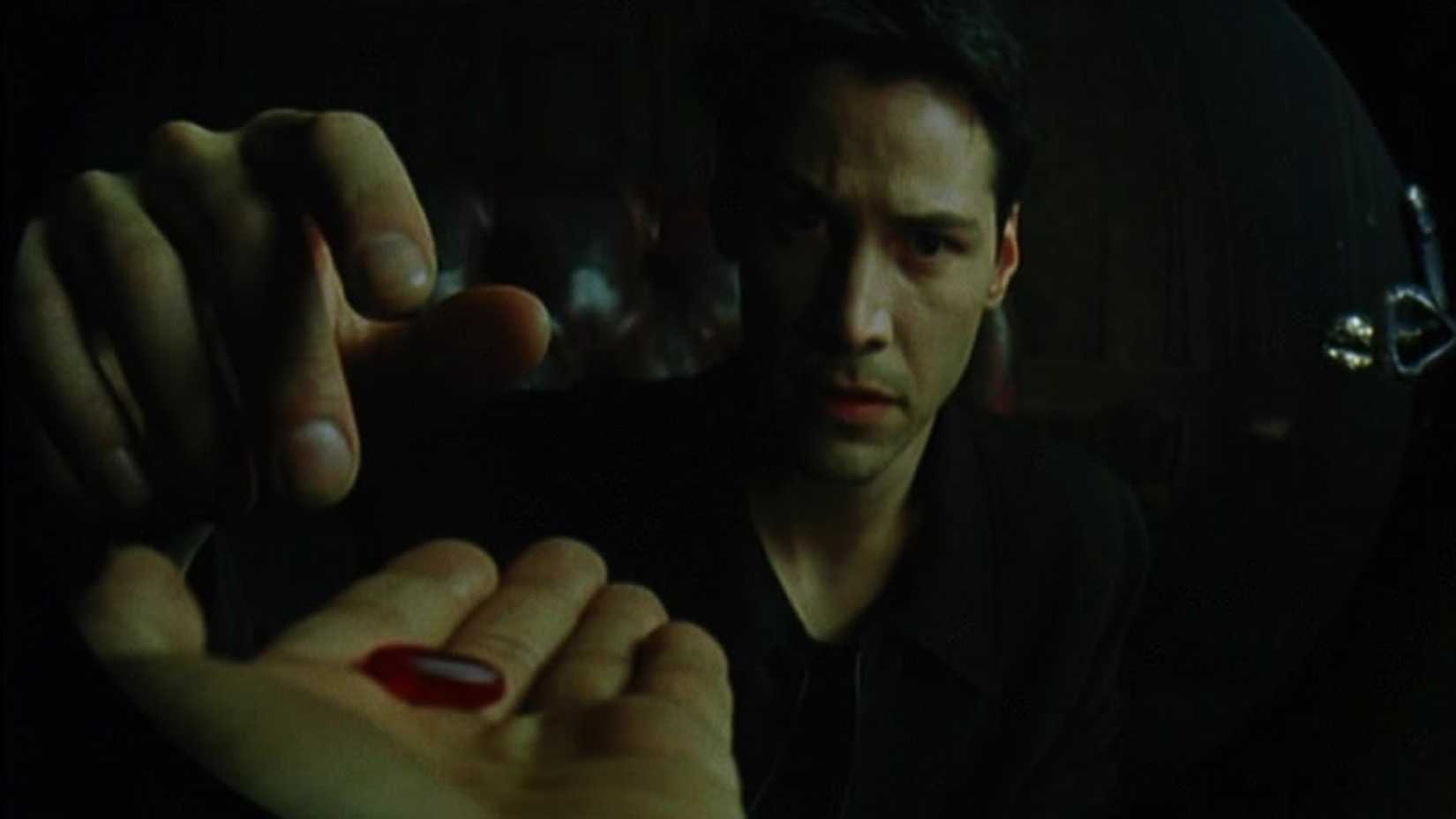 Keanu Reeves taking the red pill as Neo in 'The Matrix'