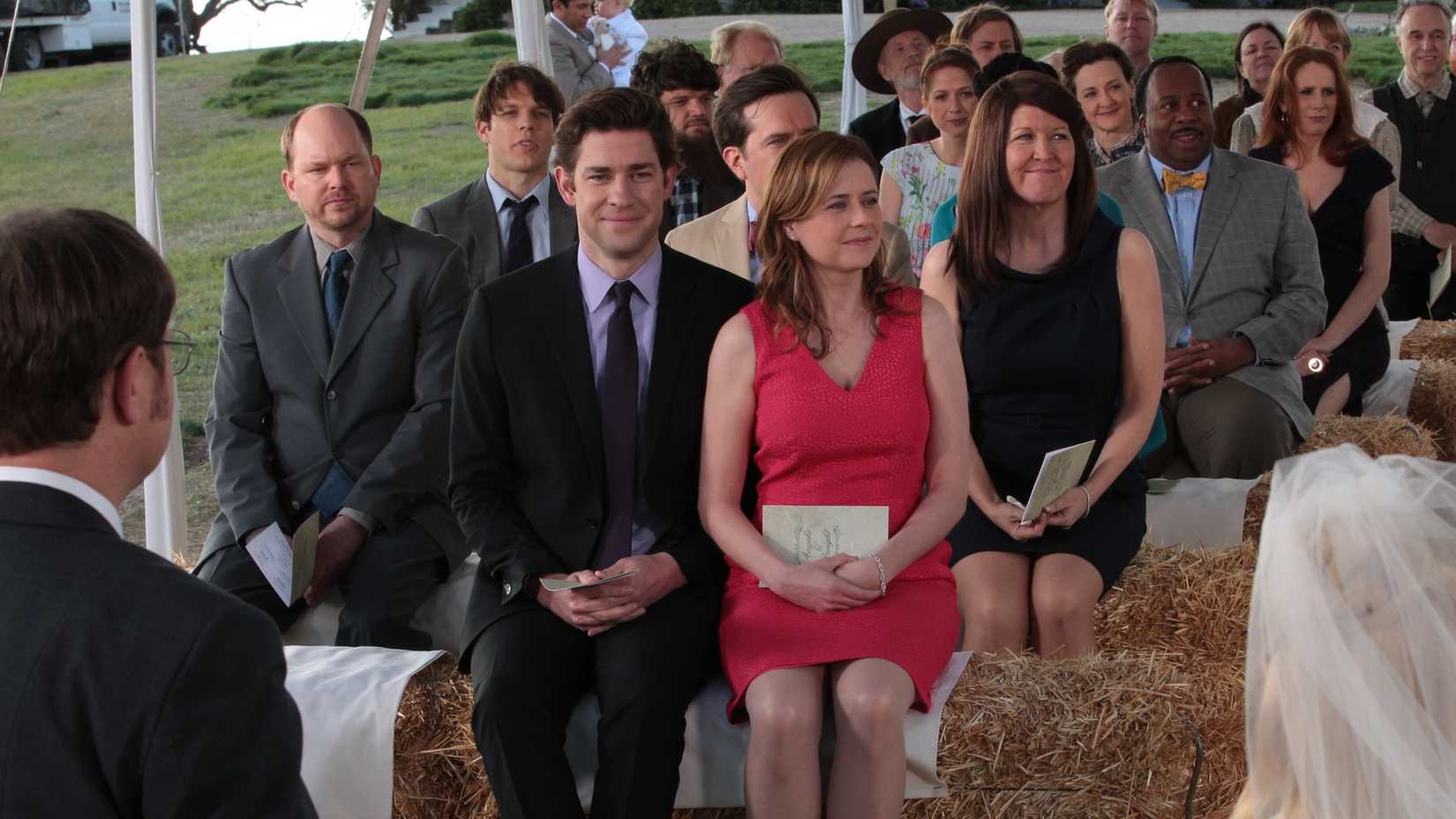 The Office cast sitting on haybells at Dwight's wedding in the Finale