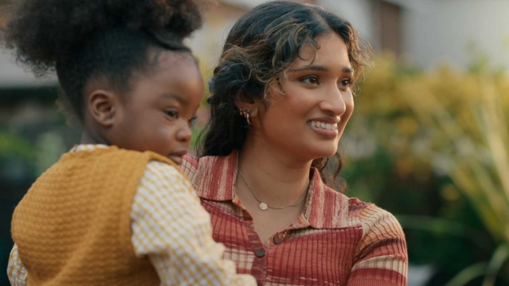 Belinda holding Poppy in their back garden as they say goodbye to the Doctor in Doctor Who's 